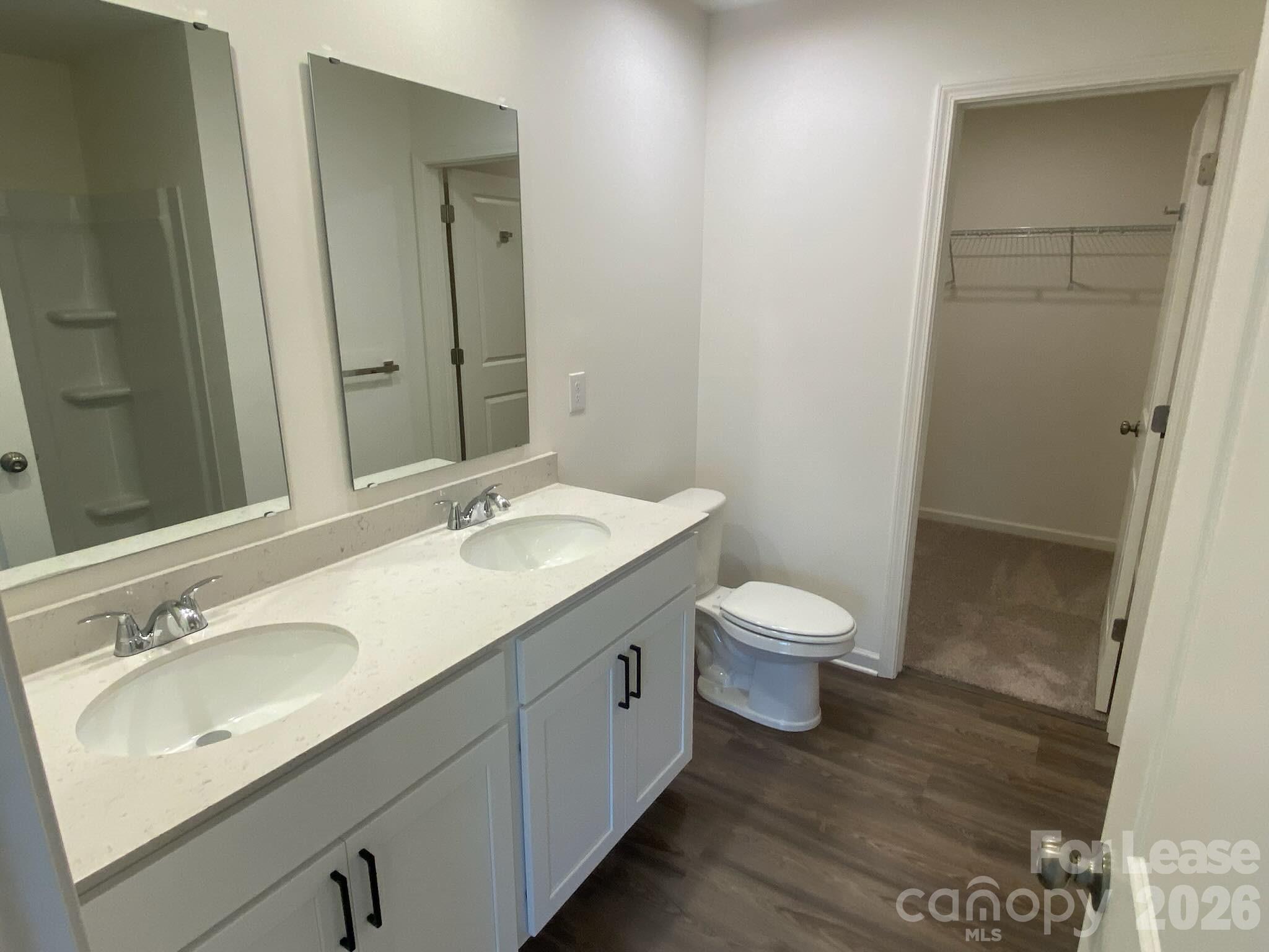 611 Richard Road Lexington, NC 27292 - Photo 6 of 10 a bathroom with a granite countertop sink toilet a large mirror and shower