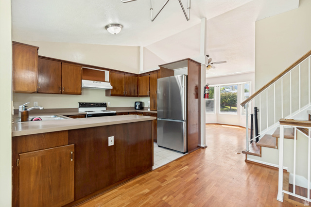 843 Deer Flat Road Tooele, UT 84074 - Photo 8 of 27 Kitchen featuring wood cabinetry, light-toned countertops, and stainless steel appliances