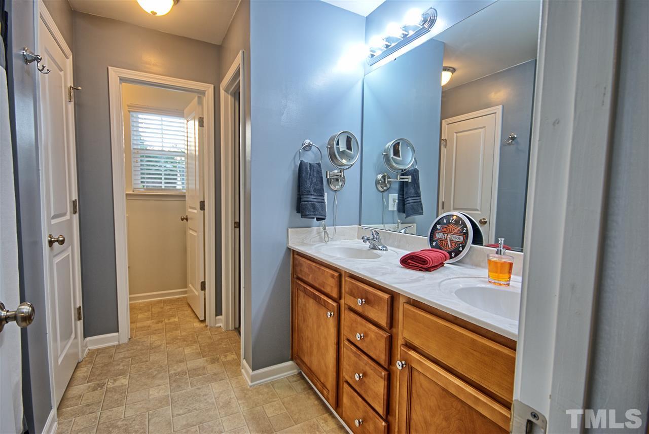 4904 Jelynn Street Raleigh, NC 27616 - Photo 13 of 25 Master Bath with Double Vanity, linen storage and private water closet.