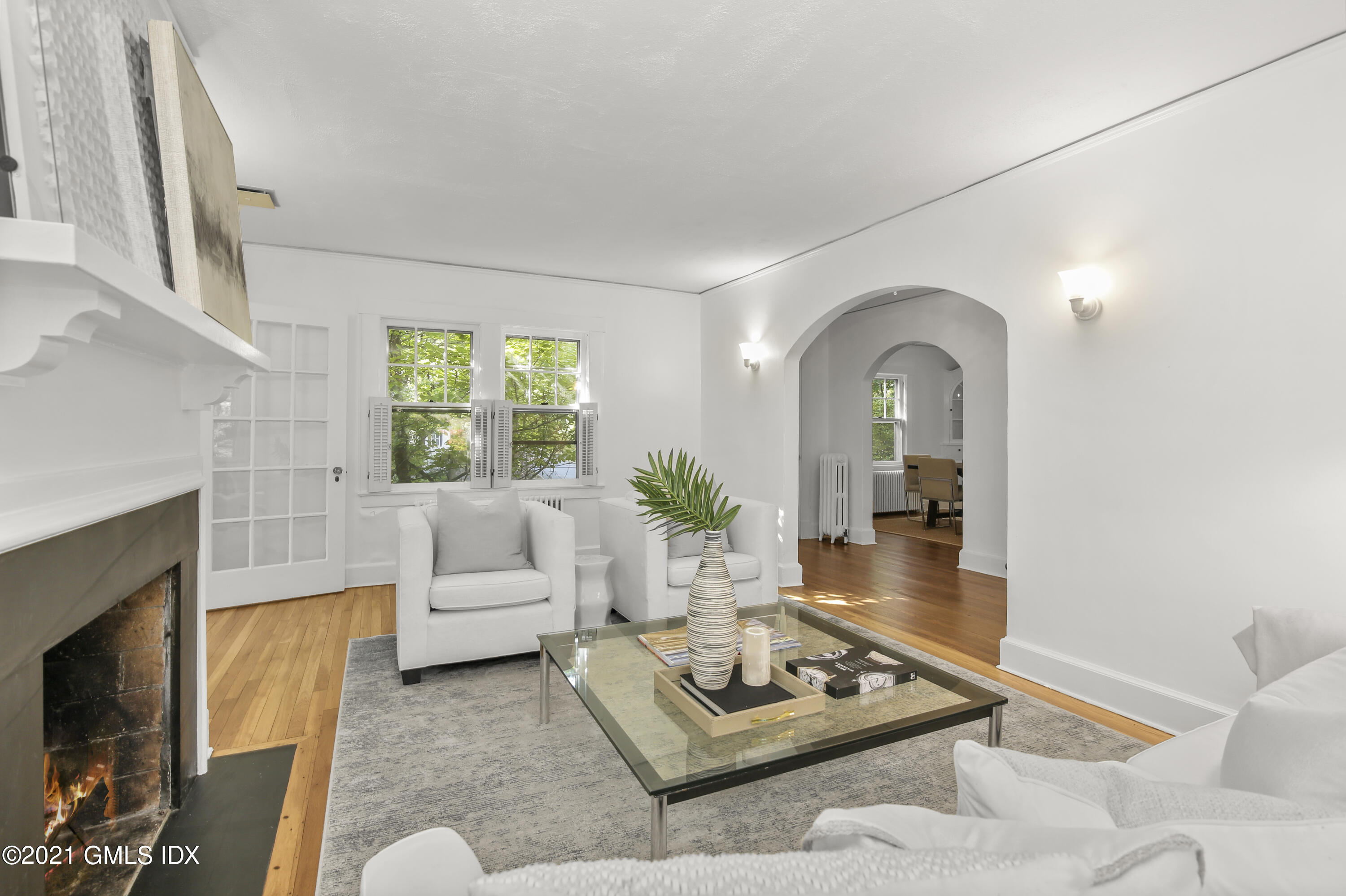 41 Butler Street Cos Cob, CT 06807 - Photo 12 of 33 a living room with furniture a rug a fireplace and a large window