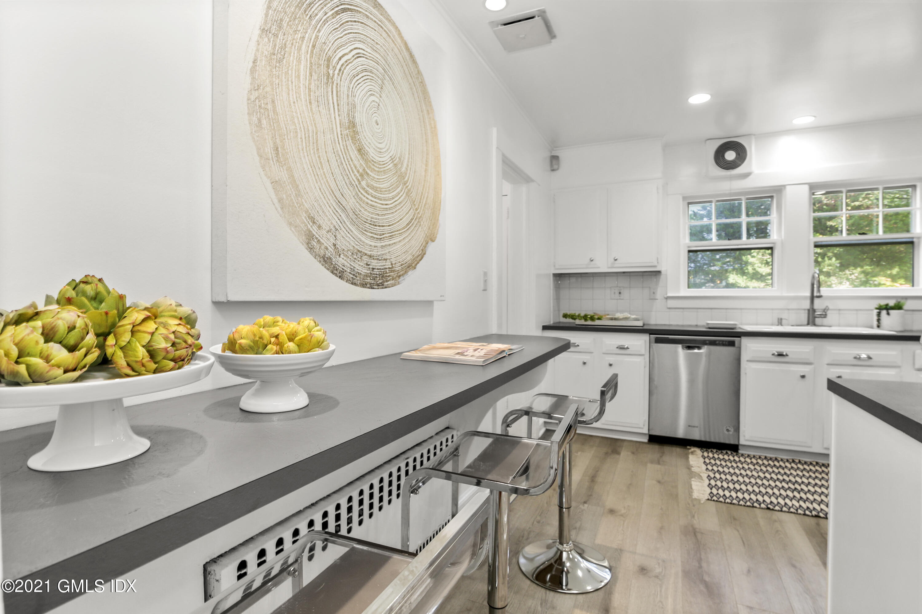 41 Butler Street Cos Cob, CT 06807 - Photo 15 of 33 a kitchen with a sink a stove and a wooden floor