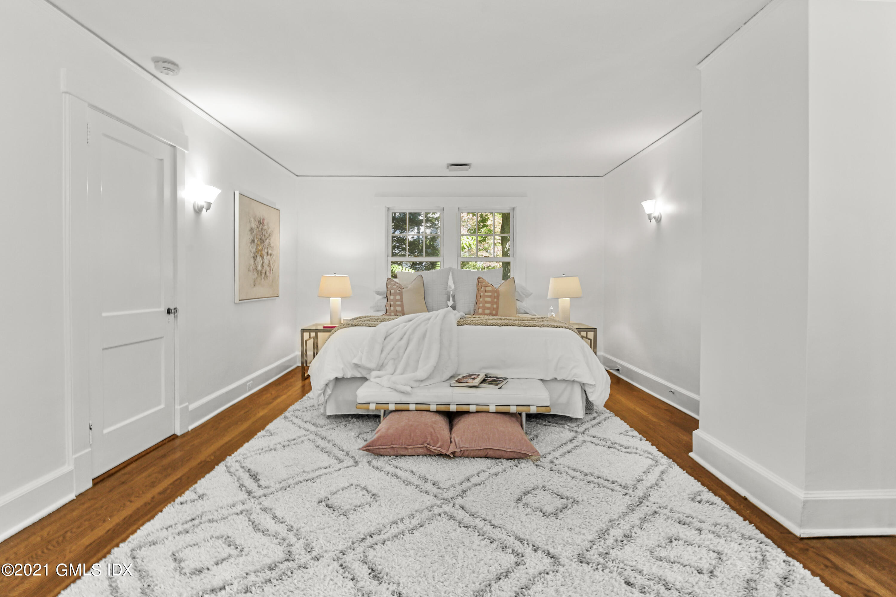 41 Butler Street Cos Cob, CT 06807 - Photo 18 of 33 a large bedroom with a bed and wooden floor