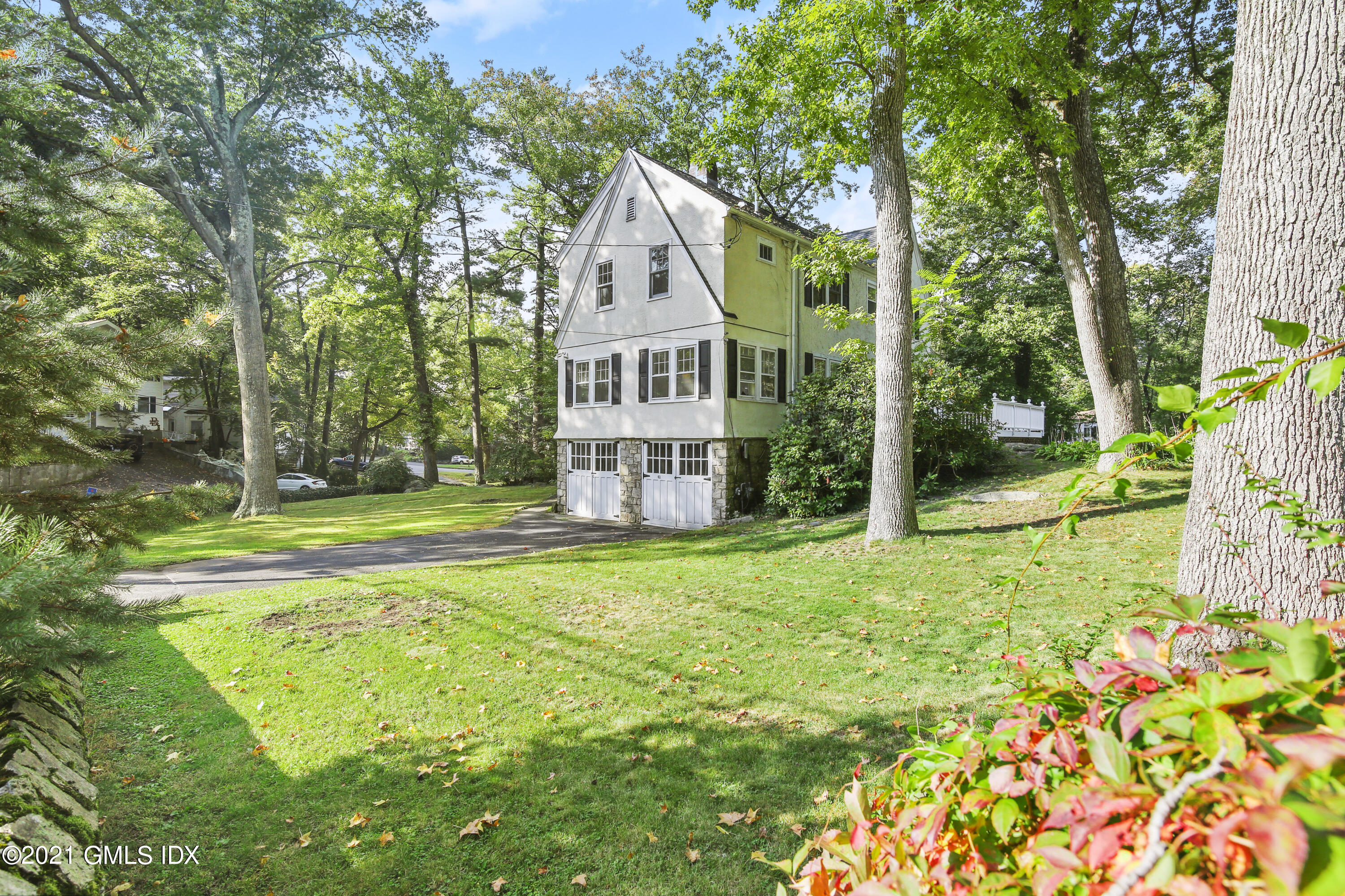 41 Butler Street Cos Cob, CT 06807 - Photo 25 of 33 a view of a house with garden and trees