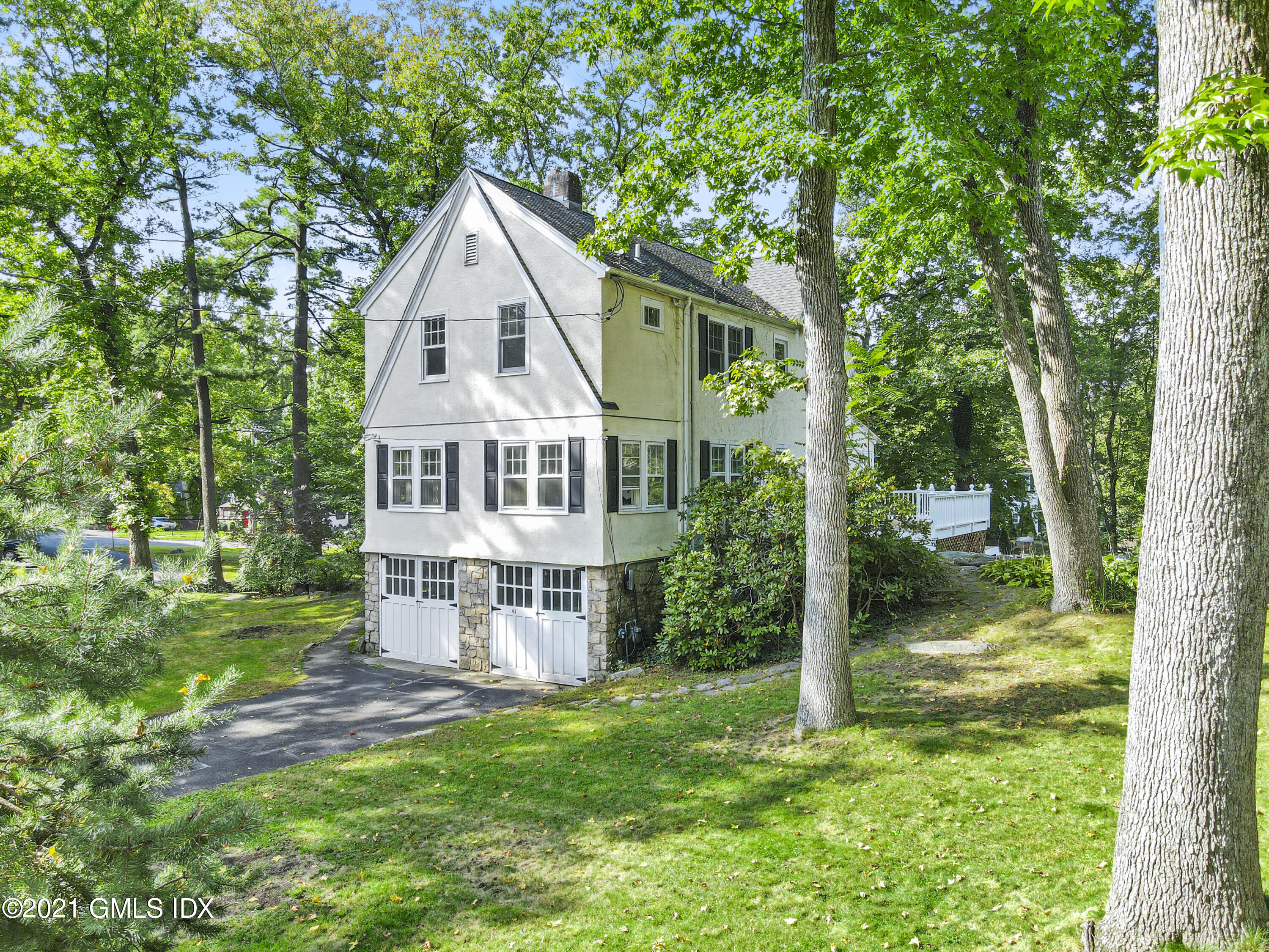 41 Butler Street Cos Cob, CT 06807 - Photo 4 of 33 a front view of a house with a yard table and chairs