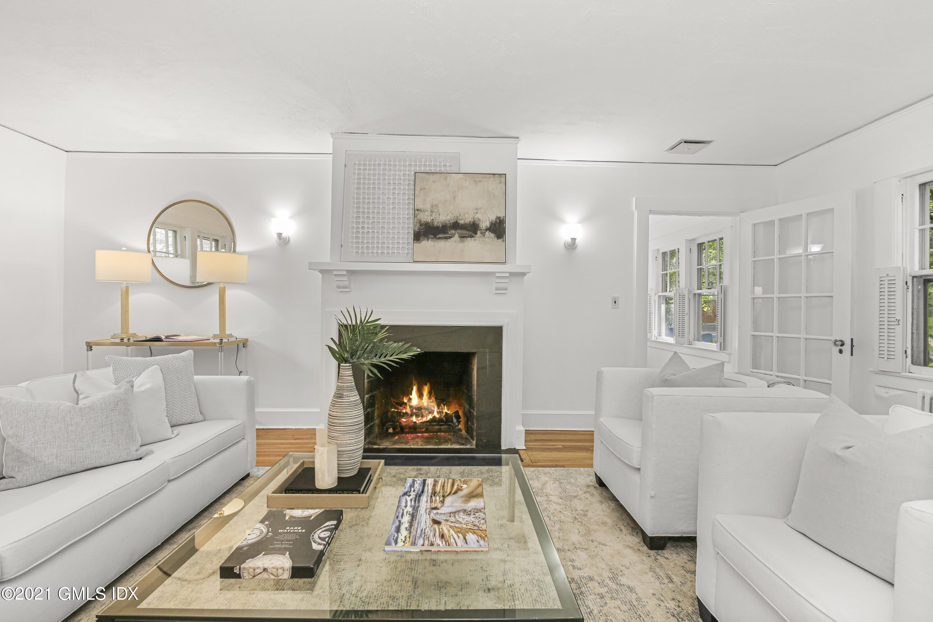 41 Butler Street Cos Cob, CT 06807 - Photo 10 of 33 a living room with furniture a fireplace and a large mirror