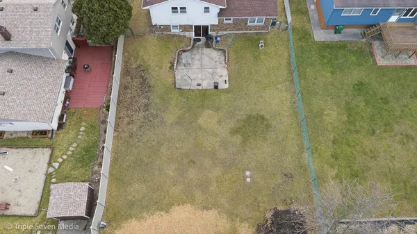 an aerial view of residential house with pool and yard