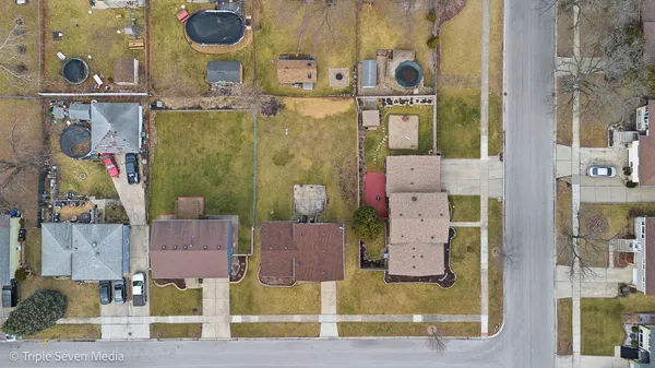 an aerial view of residential houses with outdoor space