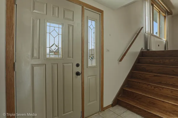 a view of staircase with lots of frames on wall and black walls