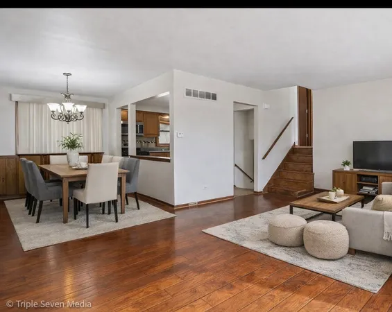 a dining room with furniture and wooden floor