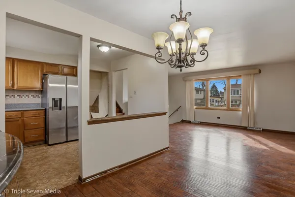 a view of a kitchen with stainless steel appliances granite countertop a refrigerator