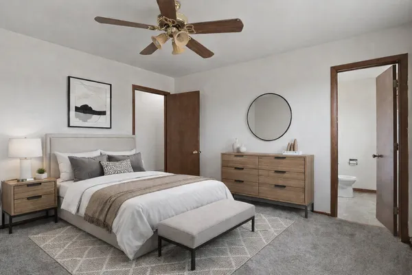 a bedroom with a bed a closet and a chandelier