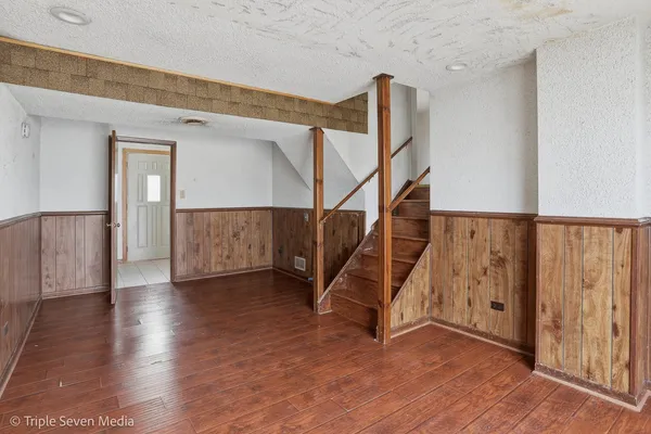 a view of an entryway with wooden floor