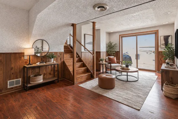 a living room with furniture and a wooden floor