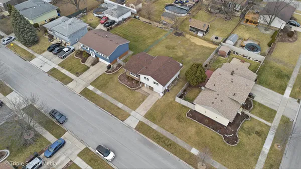 an aerial view of residential house with parking