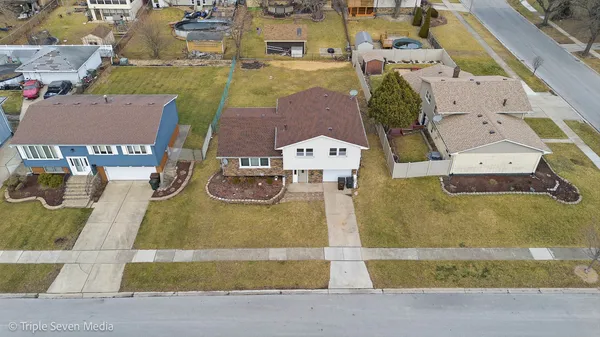 an aerial view of residential houses with outdoor space