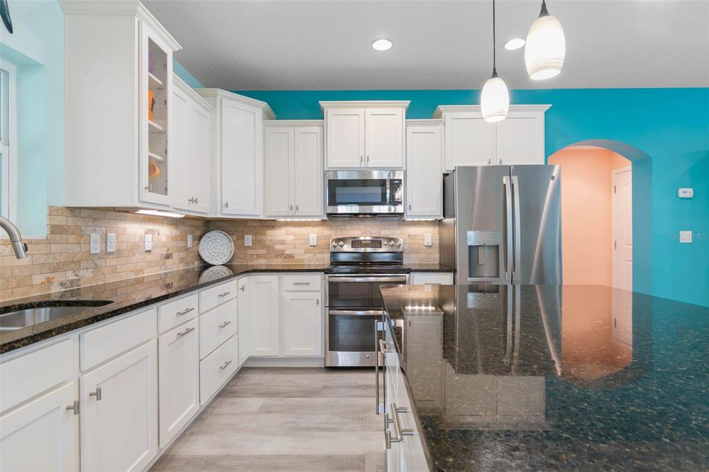 47 Sandy Beach Way Palm Coast, FL 32137 - Photo 16 of 70 a kitchen with stainless steel appliances granite countertop a refrigerator a stove and a sink