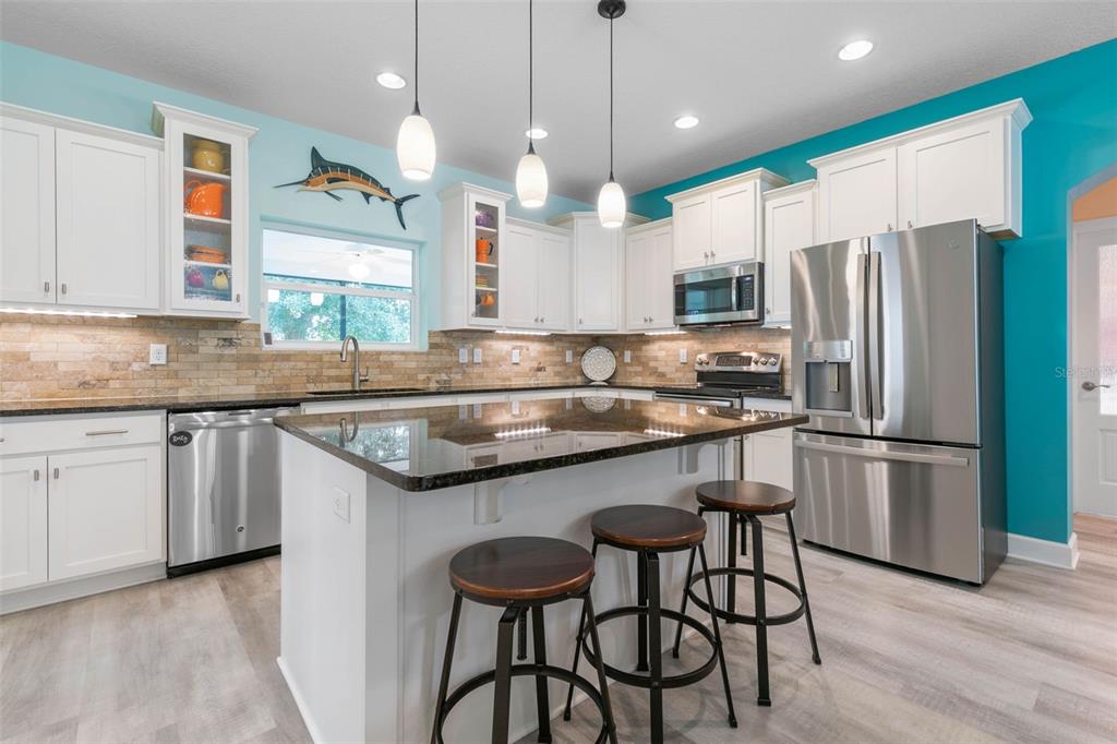 47 Sandy Beach Way Palm Coast, FL 32137 - Photo 17 of 70 a kitchen with granite countertop stainless steel appliances a sink a center island and a window