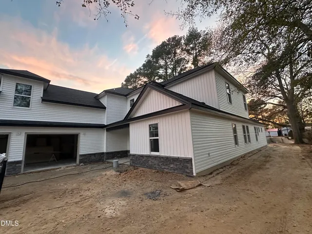 a view of a house with a yard and garage