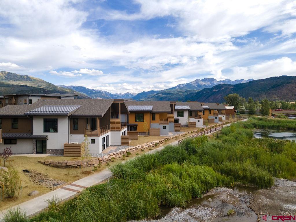 154 Alpine Lane, Unit 200 Ridgway, CO 81432 - Photo 15 of 29 a front view of a house with a yard table and chairs