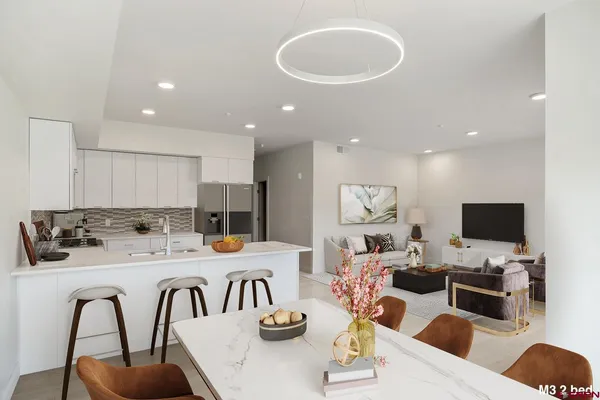 a dining room with furniture a fireplace and a flat screen tv