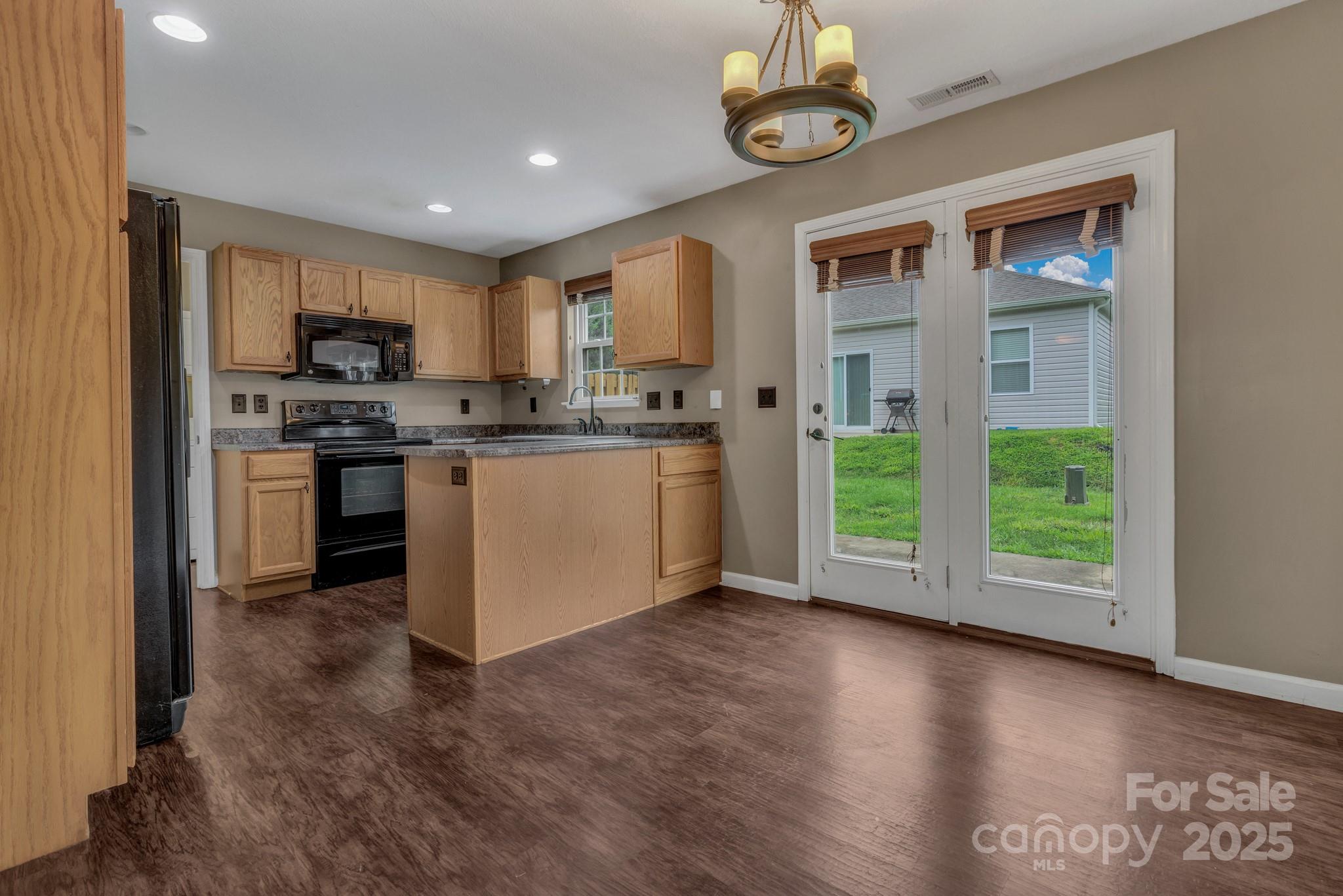4 Lilac Fields Way Arden, NC 28704 - Photo 16 of 33 a kitchen with stainless steel appliances granite countertop a stove top oven a sink and a refrigerator