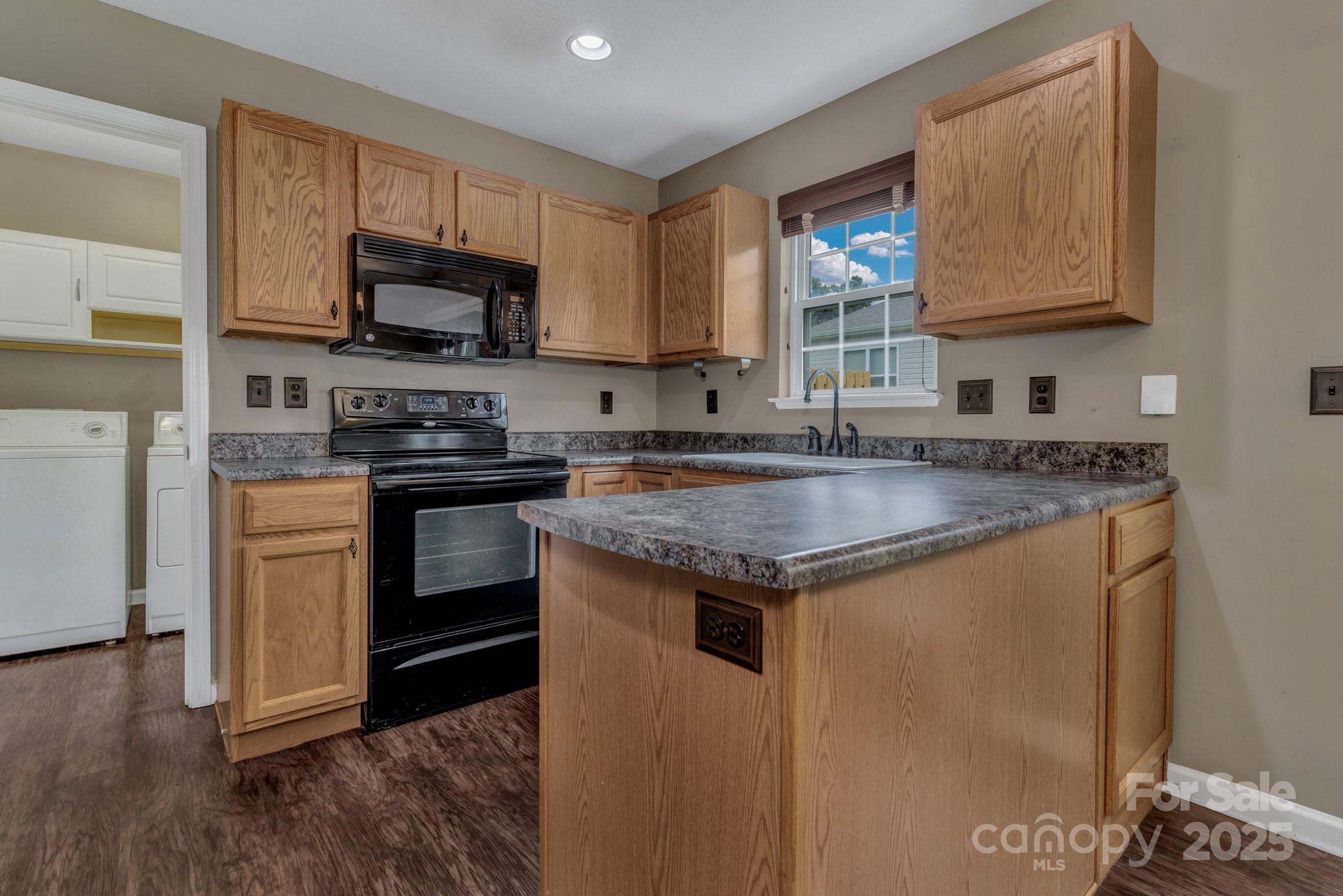 4 Lilac Fields Way Arden, NC 28704 - Photo 9 of 33 a kitchen with stainless steel appliances granite countertop a stove a sink and a microwave
