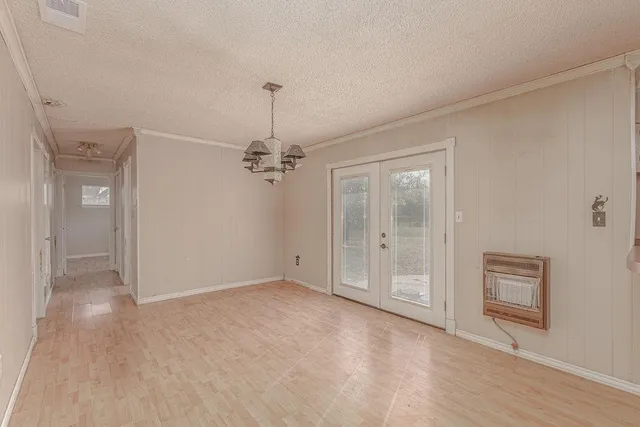 a view of a kitchen with refrigerator and wooden floor