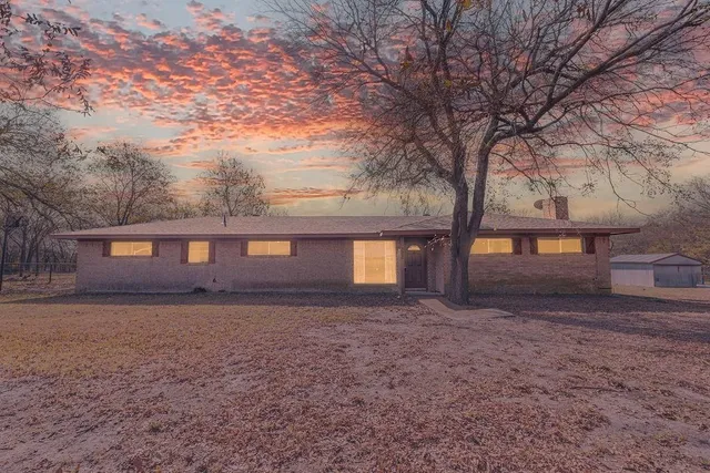 a front view of house with yard and trees