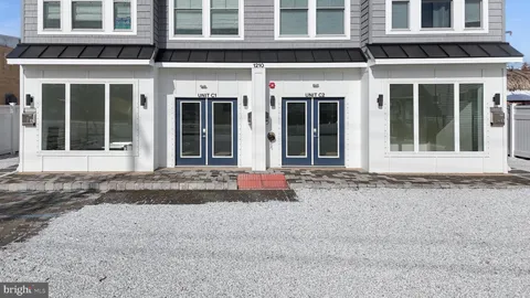 front view of a brick house with a plants