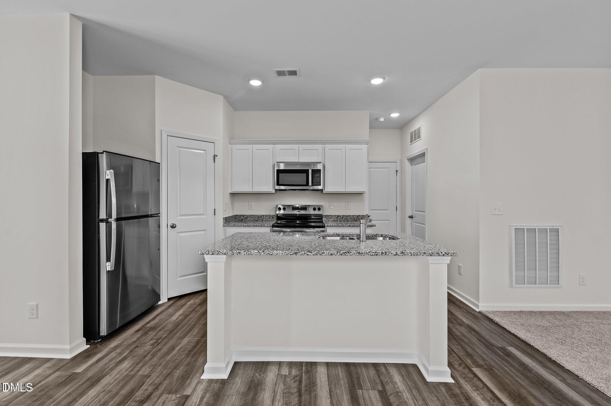 646 Essex Road Nashville, NC 27856 - Photo 5 of 24 a kitchen with stainless steel appliances granite countertop a refrigerator and a stove top oven