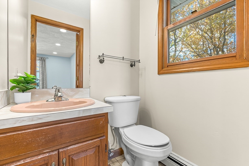 25 Murdoch Road Stoneham, MA 02180 - Photo 19 of 39 a bathroom with a sink a toilet and a mirror