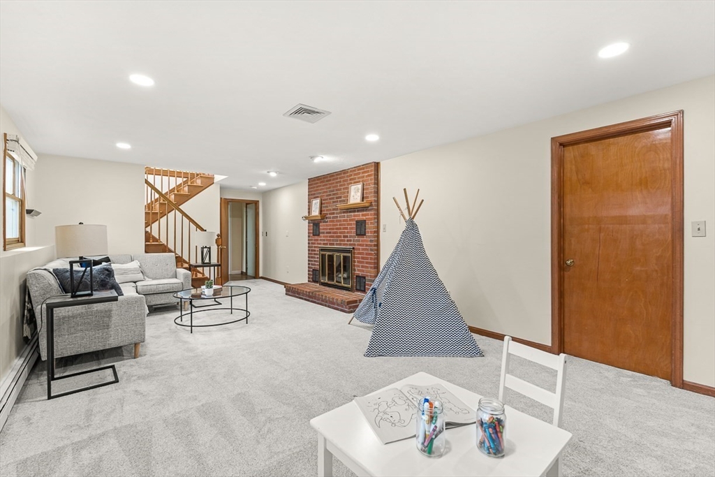 25 Murdoch Road Stoneham, MA 02180 - Photo 23 of 39 a living room with furniture and gym equipment