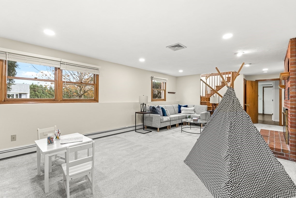 25 Murdoch Road Stoneham, MA 02180 - Photo 24 of 39 a living room with furniture and a wooden floor