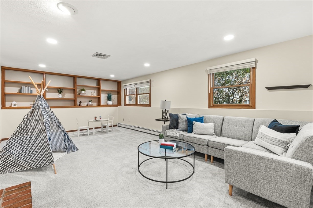 25 Murdoch Road Stoneham, MA 02180 - Photo 26 of 39 a living room with furniture a air conditioner vent and a window