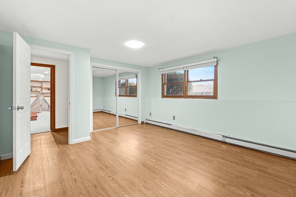 25 Murdoch Road Stoneham, MA 02180 - Photo 30 of 39 an empty room with wooden floor and windows