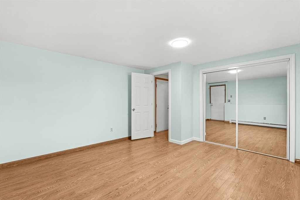 25 Murdoch Road Stoneham, MA 02180 - Photo 32 of 39 an empty room with wooden floor and white walls