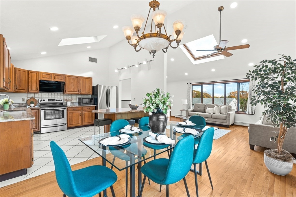25 Murdoch Road Stoneham, MA 02180 - Photo 6 of 39 a view of a dining room with furniture a chandelier and wooden floor