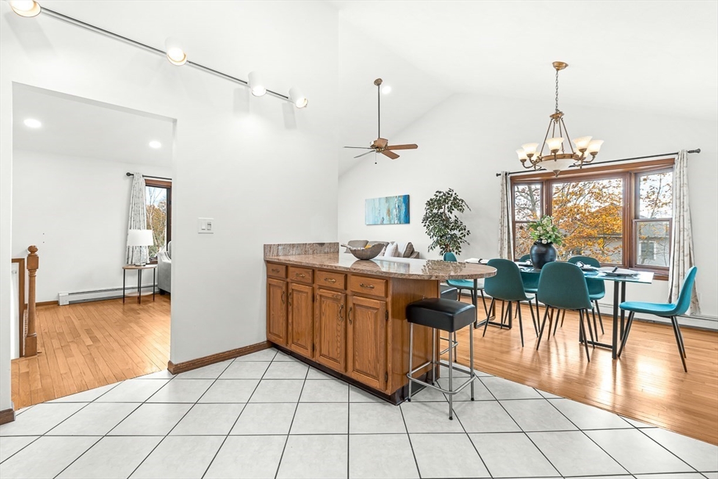 25 Murdoch Road Stoneham, MA 02180 - Photo 8 of 39 a living room with furniture a flat screen tv and a floor to ceiling window