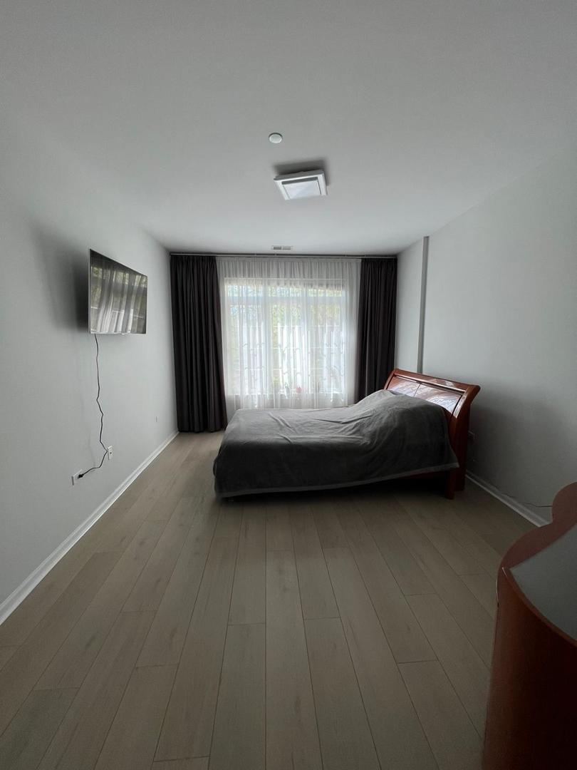 660 McHenry Road, Unit 107 Wheeling, IL 60090 - Photo 16 of 24 a bedroom with a bed and a window