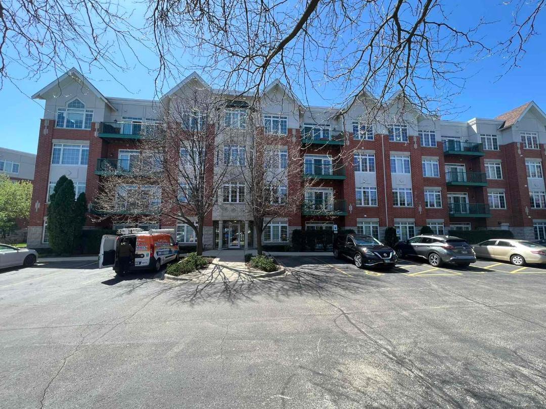 660 McHenry Road, Unit 107 Wheeling, IL 60090 - Photo 24 of 24 a car parked in front of a building