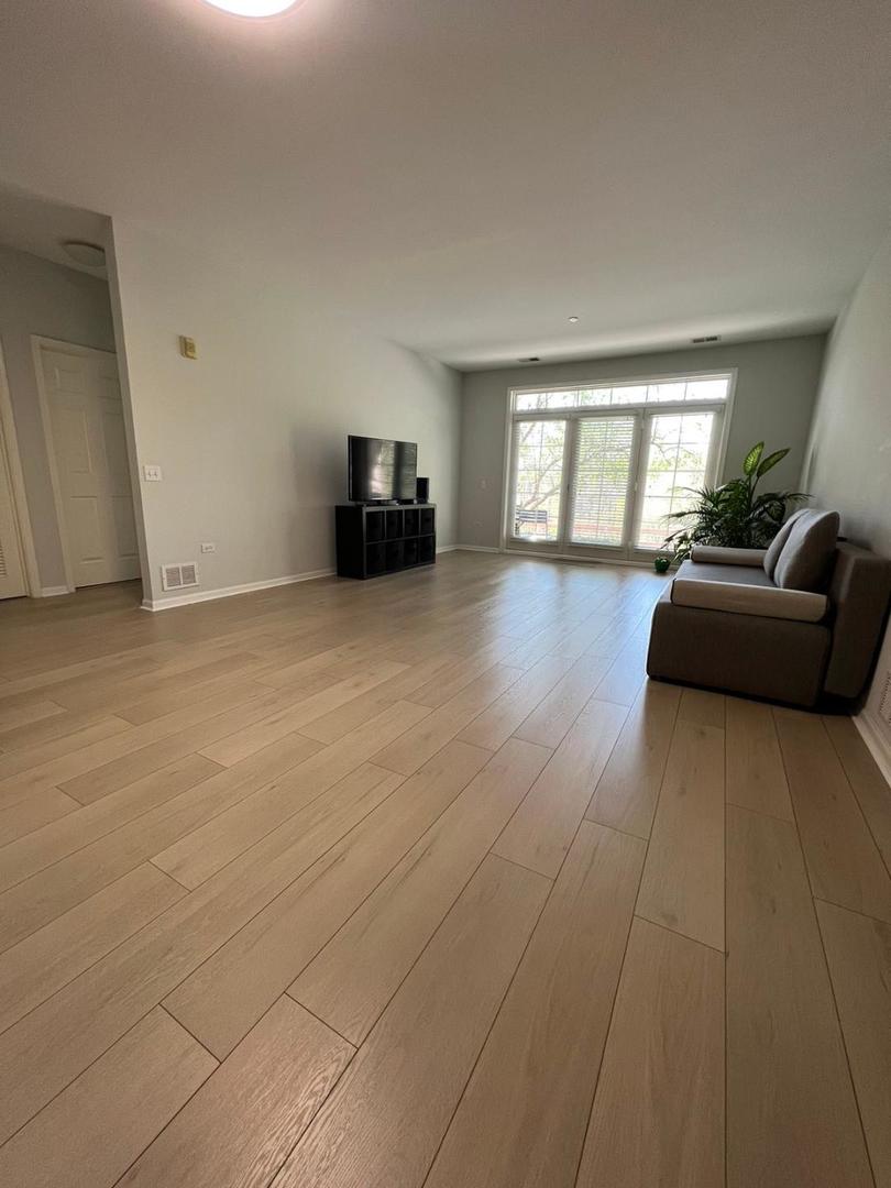 660 McHenry Road, Unit 107 Wheeling, IL 60090 - Photo 7 of 24 a living room with furniture and a window