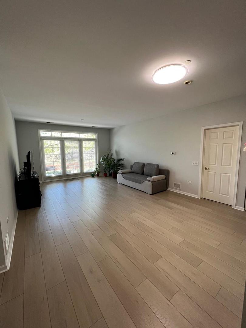 660 McHenry Road, Unit 107 Wheeling, IL 60090 - Photo 8 of 24 a living room with furniture and a window