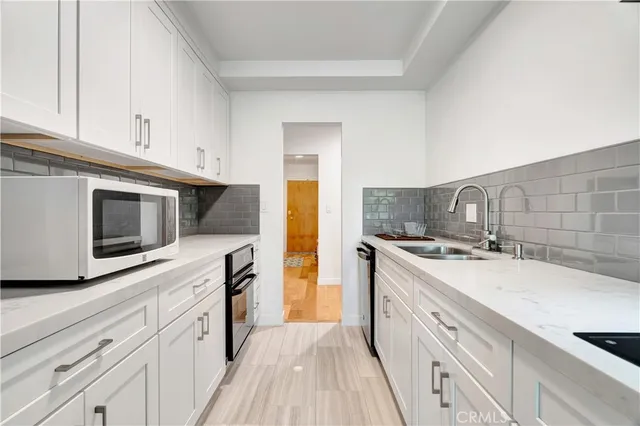 a kitchen with a sink cabinets and stainless steel appliances