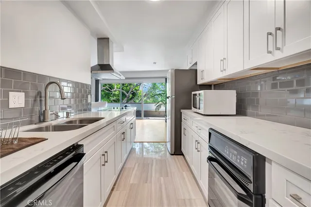 a kitchen with a sink stove and cabinets