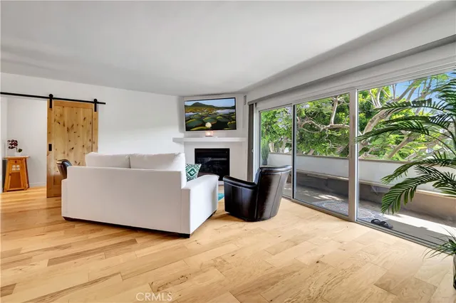 a living room with furniture a large window and a fireplace