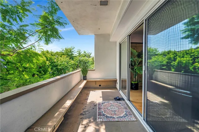 a view of a balcony with wooden floor