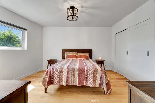 a bed sitting in a bedroom next to a window