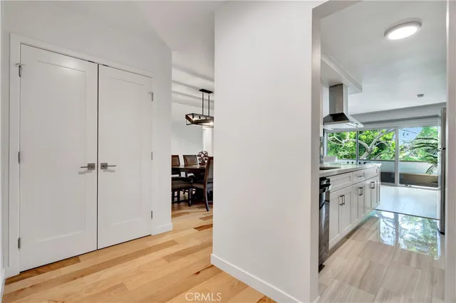 a view of walk in closet with hardwood floor