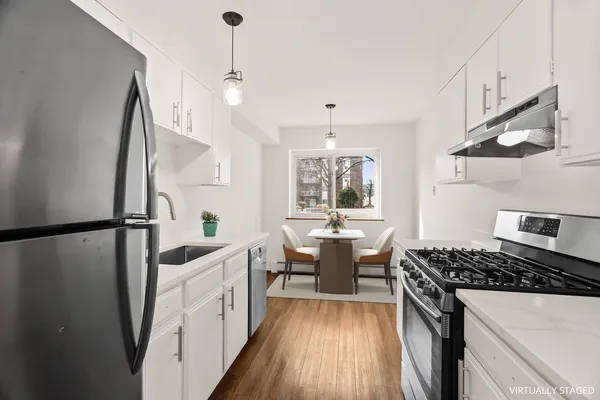 a kitchen with sink a stove and refrigerator