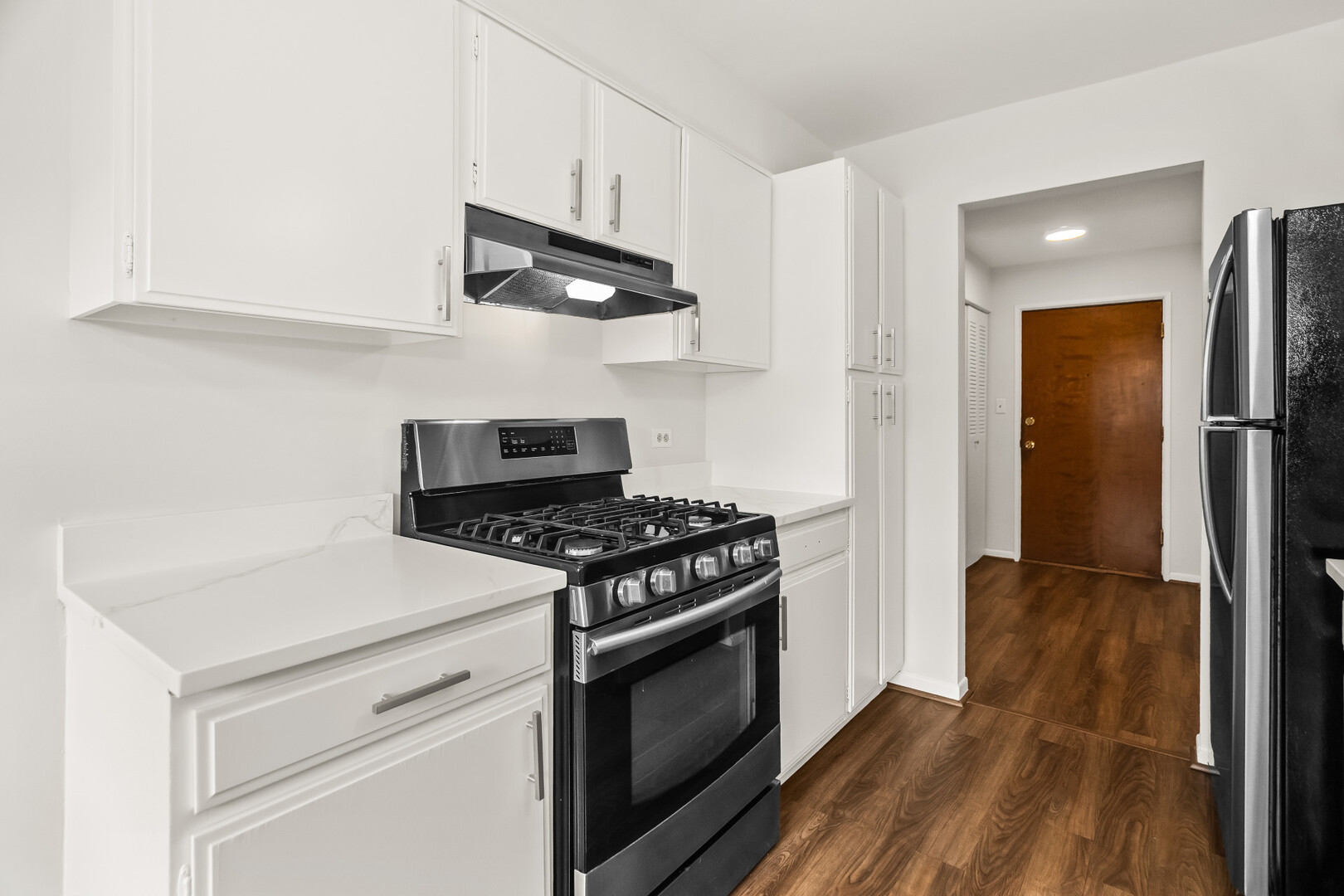 1331 South Finley Road, Unit 104 Lombard, IL 60148 - Photo 7 of 12 a kitchen with stainless steel appliances a stove and a refrigerator